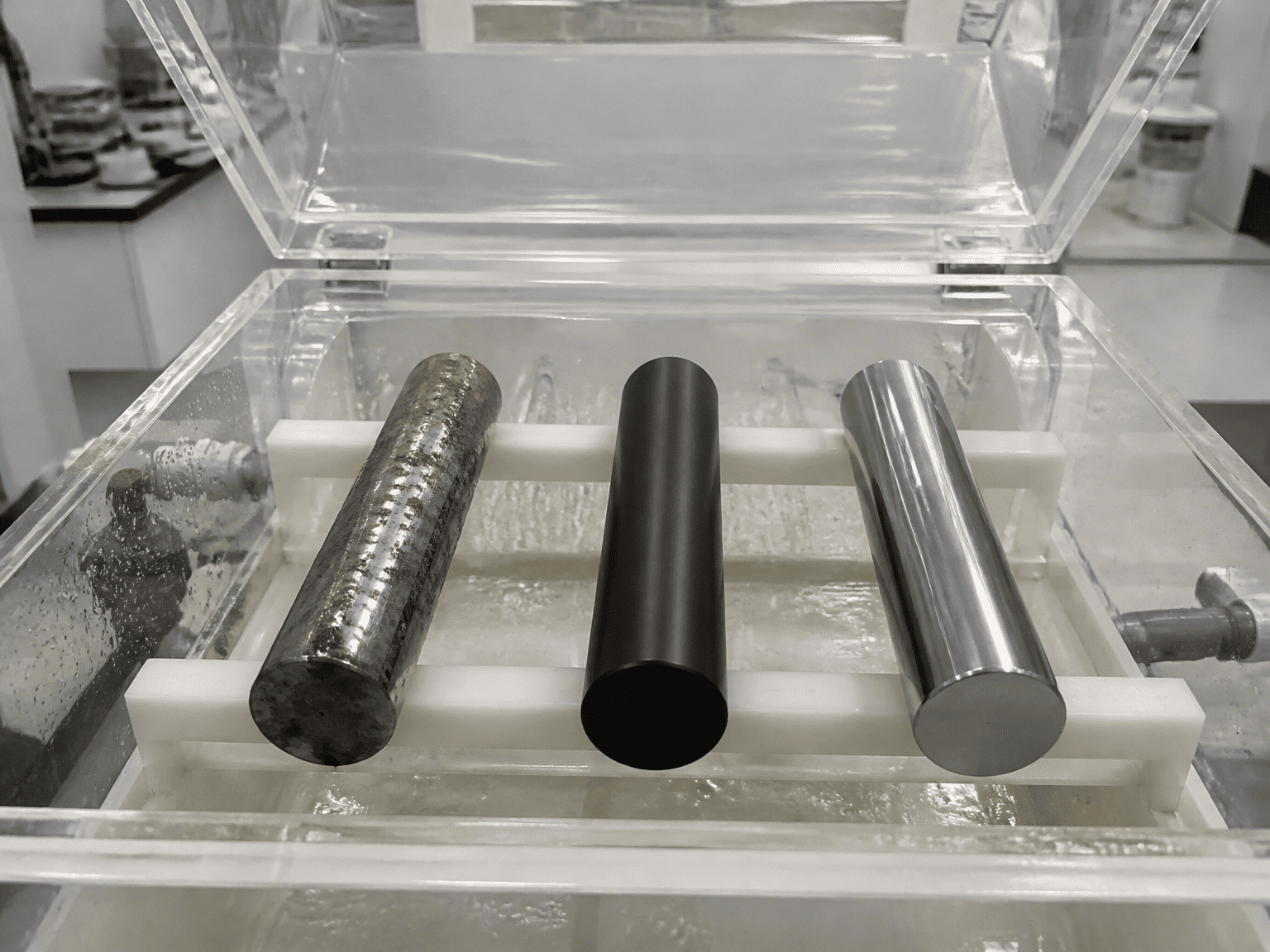 ASTM B117 salt spray corrosion test chamber showing hard chrome pitting versus QPQ nitrided rod